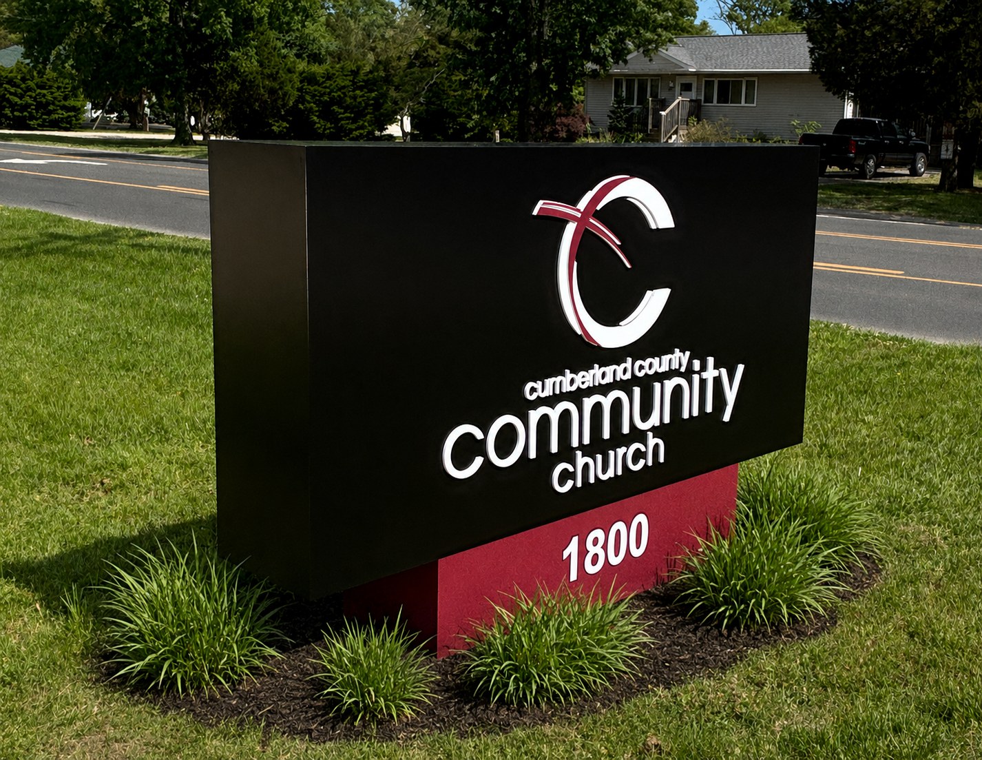 Cumberland County Community Church monument sign with illuminated lettering and landscaped base